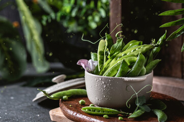 Fresh green peas on wooden table