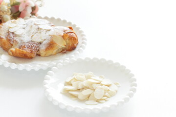 Sliced almond on white dish with copy space 