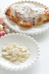 Sliced almond on white dish with copy space 