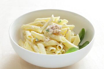 Short pasta and tuna mayonnaise salad in white bowl