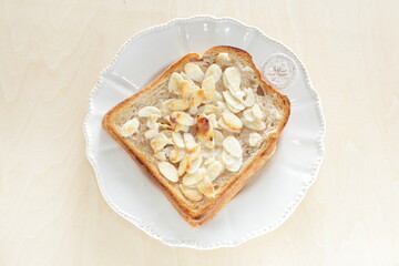sliced almond and sugar toast on dish for homemade breakfast and cafe food image