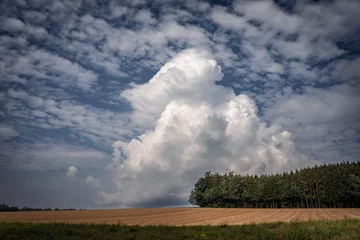 Fotobehang Storm cloud on the horizon. nature environment severe weather huge cloud in the sky stormy cloud. Bayern Germany. © CreativeImage
