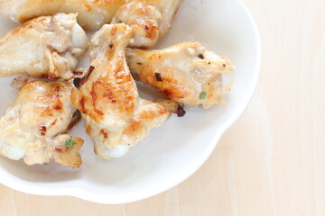 Barbecue grilled chicken drumsticks on plate with copy space