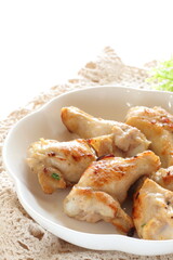 Barbecue grilled chicken drumsticks on plate with copy space