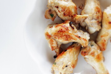 Barbecue grilled chicken drumsticks on plate with copy space