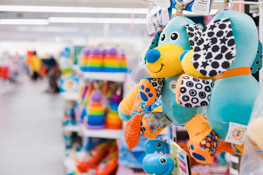 Shop toy store for babies. A soft toy close-up on a shopping trip with a blurry background.
