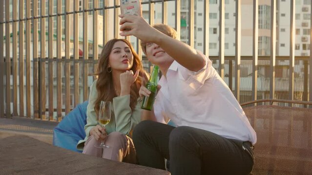 Asian couple smiling taking selfie self portrait photos on smartphone