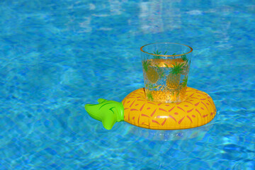 Drinks holder floating in pool with copy space