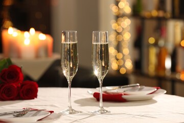 Romantic dinner table setting with glasses of champagne in restaurant