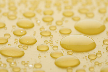 Fototapeta na wymiar Water drops on yellow background, closeup view