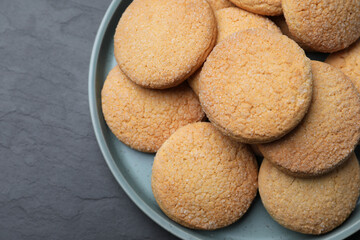 Delicious sugar cookies on black table, top view