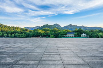 Empty square floor and green forest with mountain scenery in Hangzhou, China.