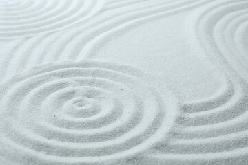 Fototapeta na wymiar White sand with pattern as background. Zen, meditation, harmony