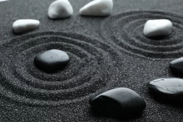  Stones on black sand with beautiful pattern. Zen and harmony © New Africa