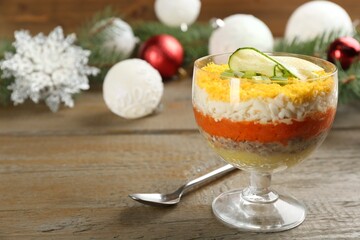 Traditional russian salad Mimosa and festive decor on wooden table. Space for text
