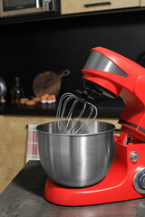 Modern stand mixer on grey table in kitchen