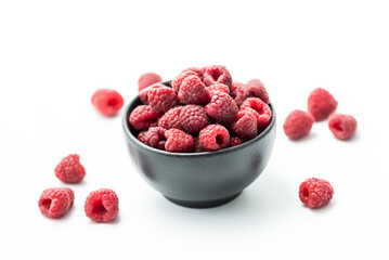 Ripe sweet raspberries in bowl on white background