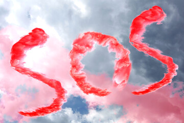 Word SOS made of red smoke in cloudy sky