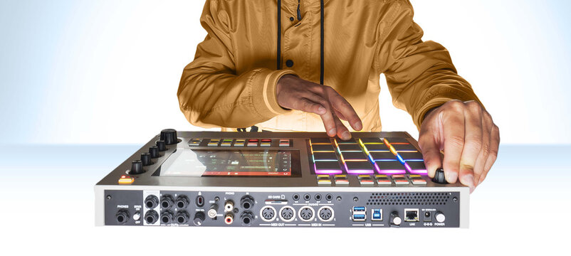Professional musician playing in studio on a white background for a music video. Beatmaker hands on the drum machine close-up at the mpc.