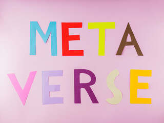 Metaverse word made from multicolored paper letters. Metaverse lettering on a pink background. Virtual reality technologies concept