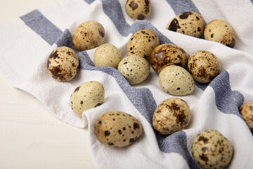Quail eggs on a white texture background. Whole and broken quail eggs. Natural products. Place for text. Fresh quail eggs.