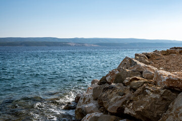 Famous Pucisca quarry visible on the Brac island shore across the sea, visible from the coast of Mimice, Croatia