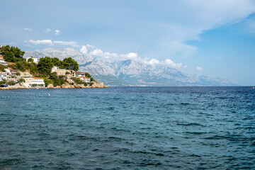 Mighty Biokovo mountain with its sharp, white rocks towering above Adriatic coast, visible from village of Mimice, Croatia