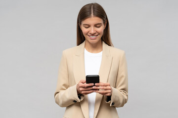 College student girl rehearsing graduation speech on gray copy space background using phone