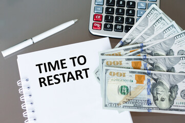 TIME TO RESTART text written in an office notebook.