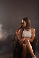 Cool trendy woman posing in smoke