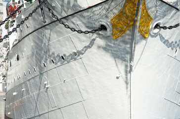 Fototapeta na wymiar Bow of a white sailboat anchored in the harbor