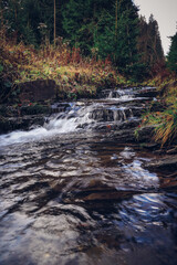 Breathtaking morning at the river Recice in Masarykovo udoli in Beskydy mountains in eastern Czech republic. A frosty and cold morning with rays of the sun illuminating the snow and the flowing river