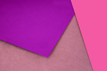 Plain and Textured pink purple brown papers randomly laying to form M like pattern and triangle for creative cover design idea