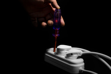 Checking electrical outlet with a volt indicator, shows the electricity with flashing light
