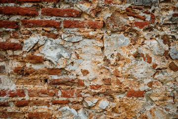 Aged red brick wall background. Eroded mortar texture wall.