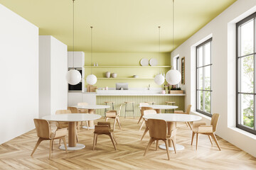 Green cafe interior with cooking and eating area, countertop and window