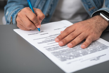 Businessman wearing casual wear sitting signing contract at office workplace