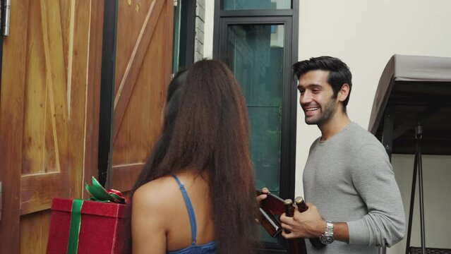 Couple knocking the door for visiting friend home.