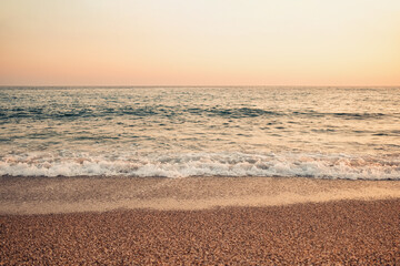 Beautiful abstract nature background with sea orange sunset on the coastline