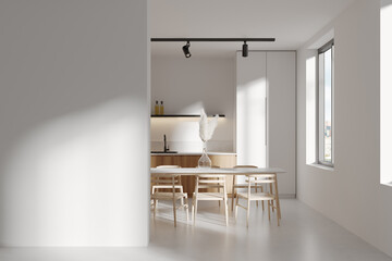Light kitchen interior with eating table and seats, kitchenware. Mockup