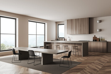 Light kitchen interior with bar countertop, dining table and panoramic window