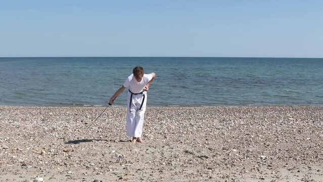 Teenage Boy Doing Karate on A Beach