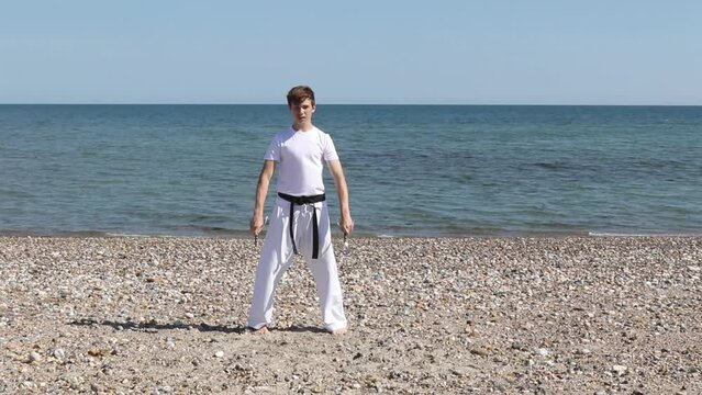 Teenage Boy Doing Karate on A Beach