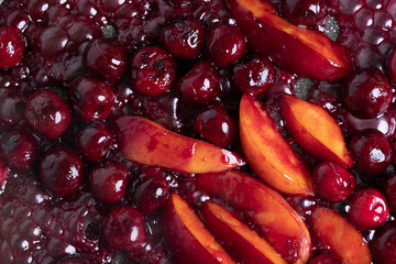 Close-up of delicious, caramelized cherries and nectarines in pan. Appetizing pan-fried fruits for dessert. Excellent image for homemade dessert banners and advertisements.
