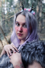 fairy in purple in the forest