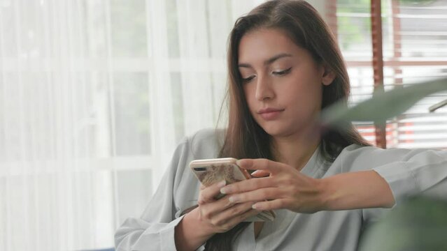 Happy relaxed woman spending time at home with cell gadget technology