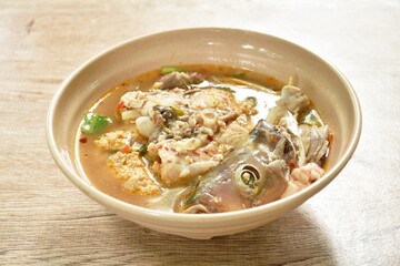 boiled Cyprinidae spicy Cyprinidae fish head and meat in Tom Yum soup on bowl