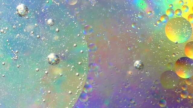 Swirling and popping multicolored oil bubbles. Abstract background.