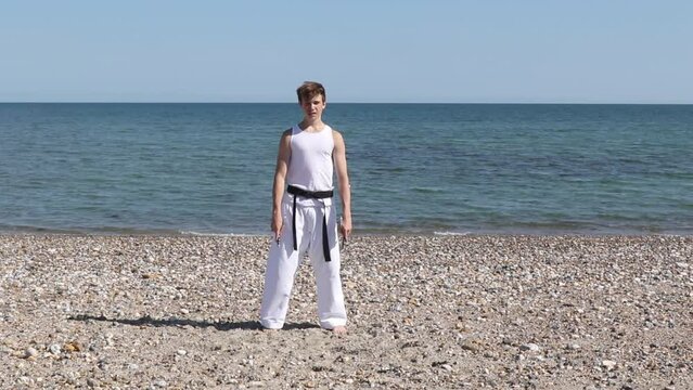 Teenage Boy Doing Karate on A Beach