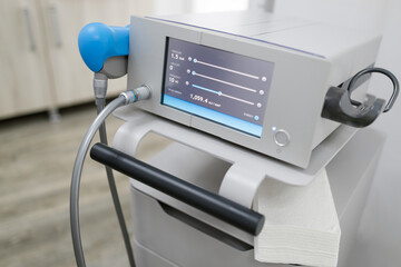 Close up view of modern device shock wave ultrasound in medical office. Physiotherapy...
